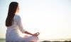 woman-sitting-in-yoga-pose-on-the-beach